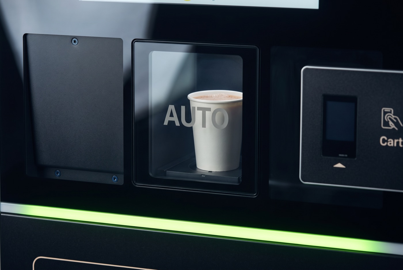 A freshly blended protein shake in a cup sitting behind the dispensing window of nest one.